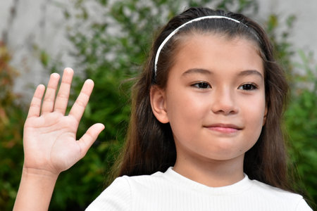 Friendly Youthful Asian Female Kid Outdoorsの写真素材