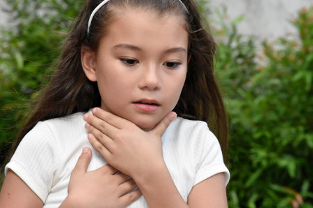 A Female Child And Illness Outsideの写真素材
