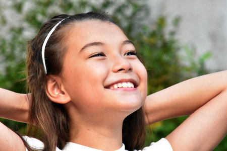 A Daydreaming Philippina Female Child Outsideの写真素材