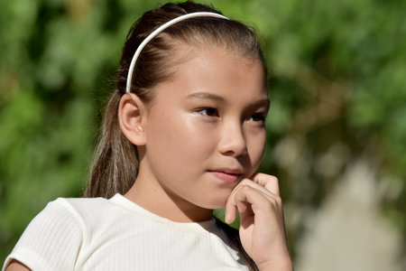 A Thoughtful Youthful Filipina Girl Outsideの写真素材