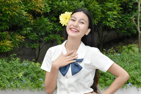Optimistic Young Minority Female Woman With Yellow Flowerの写真素材