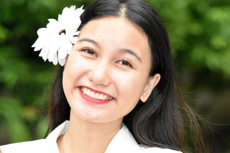 Smiling Face Of Adult Female With White Flowerの写真素材