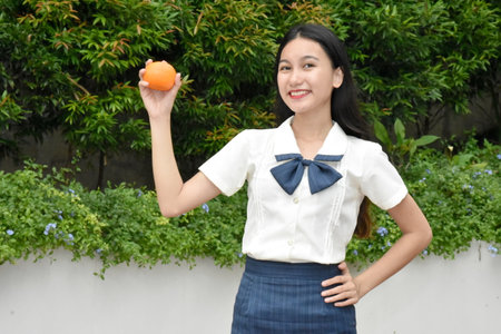 Youthful Minority Female Smiling Wearing Skirt With Foodの写真素材