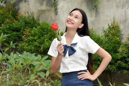 Young Philippine Woman Wearing School Uniform With Flowersの写真素材