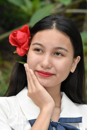 Unemotional Young Asian Female Red Flowerの写真素材
