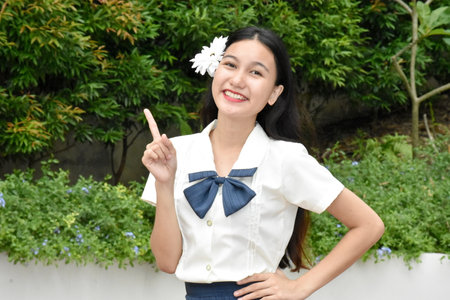 Youthful Diverse Female Smiling Wearing Skirt With White Flowerの写真素材