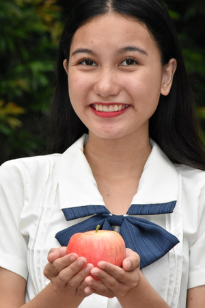 Happy Youthful Adult Female Wearing Dress With Applesの写真素材