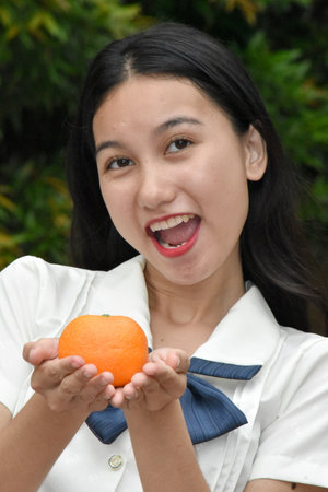 Happy Minority Female Adult Wearing Bowtie With Fruitの写真素材