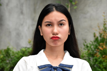 A Suspicious Asian Woman Raised Eyebrowの写真素材