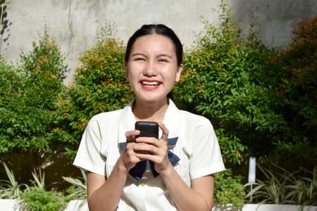 Attractive Filipina Female Posing With Mobile Phoneの写真素材