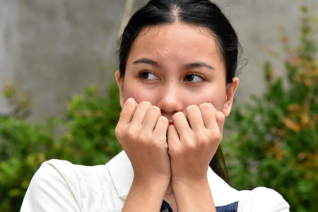 A Shy Or Fearful Asian Womanの写真素材