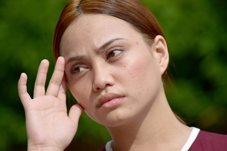 Redhead Female With Headache Wearing Tshirtの写真素材