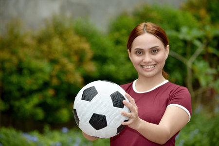 Happy Diverse Female Woman With A Ball Outsideの写真素材