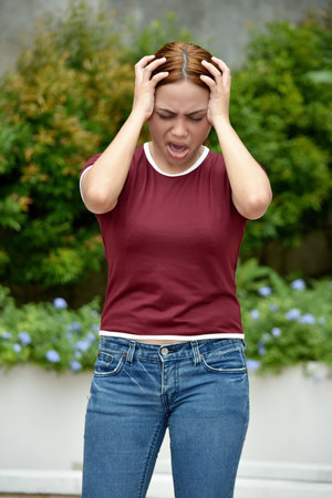 Attractive Adult And Anxiety Wearing Jeans Standingの写真素材