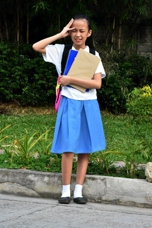 Female Student Under Stress Wearing Skirt With Textbooks Standingの写真素材