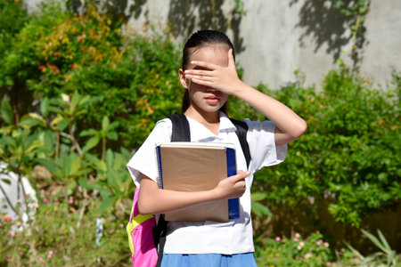 Shy Young Minority Person With Booksの写真素材