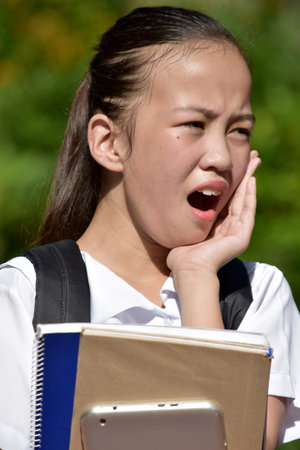 A Young Girl Student With Toothacheの写真素材