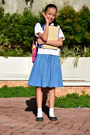 Happy Cute Filipina School Girl Standingの写真素材