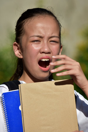 School Girl With The Flu With Booksの写真素材