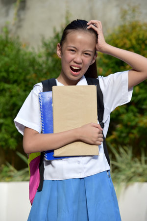 Shocked Young Girl Student With Textbooksの写真素材