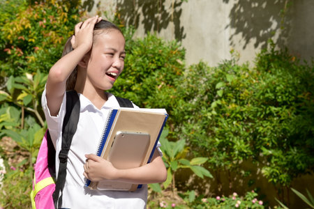 A Forgetful Cute Filipina Girl Studentの写真素材