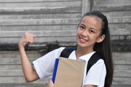 Female Student And Muscles With Textbooksの写真素材