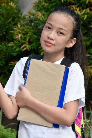 Indecisive Student Teenager School Girl Wearing Backpack With Notebooksの写真素材