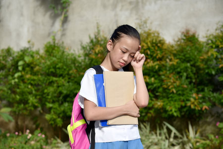 Depressed Cute Girl Student With Notebooksの写真素材