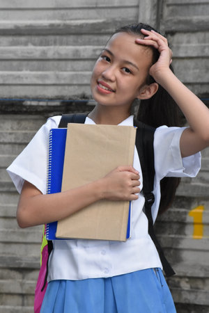 Contemplative Youthful Minority Person With School Booksの写真素材