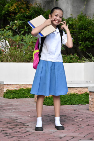 Girl Student Making Funny Faces Standingの写真素材