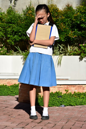Minority School Girl And Anxiety Wearing Bookbag With Textbooks Standingの写真素材