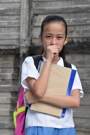 Sick Youthful Girl Student Wearing Uniformの写真素材
