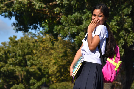 Bashful Cute Filipina Girl Student Wearing Uniform With Backpackの写真素材