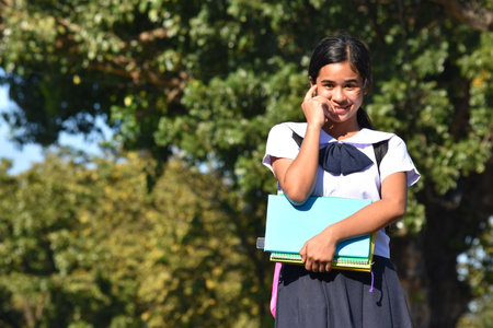 Pretty Student Teenager School Girl Making A Decision Wearing Uniformの写真素材