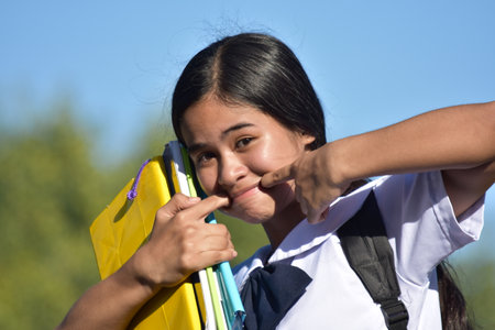 Filipina Girl Student Making Funny Faces Wearing School Uniformの写真素材