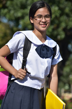 Student Teenager School Girl And Happiness Wearing Glasses With Textbooksの写真素材