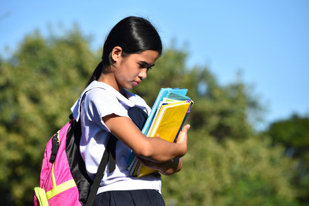Filipina Girl Student And Sadness Wearing Bookbag With Textbooksの写真素材