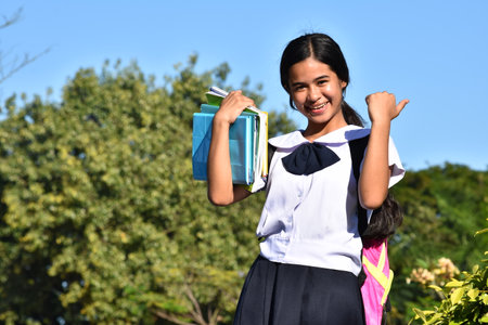 Successful Diverse Student Teenager School Girl With Booksの写真素材