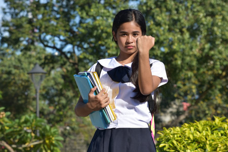 Upset Pretty Female Student Wearing School Uniformの写真素材