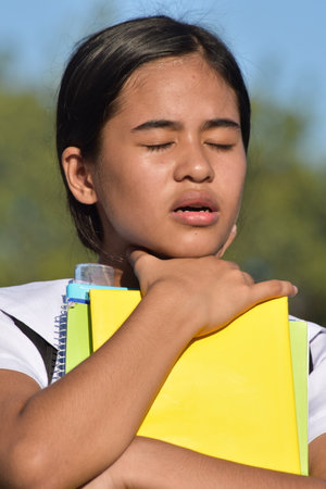 Youthful Philippine Girl Choking With Booksの写真素材