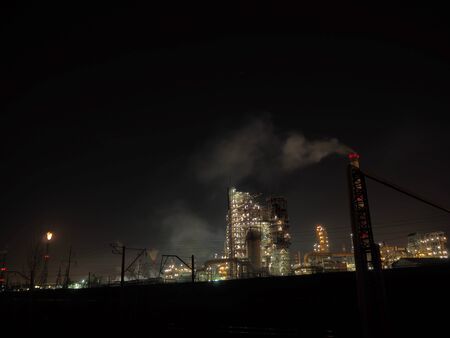 industrial stuff during a night with lights and smokesの写真素材