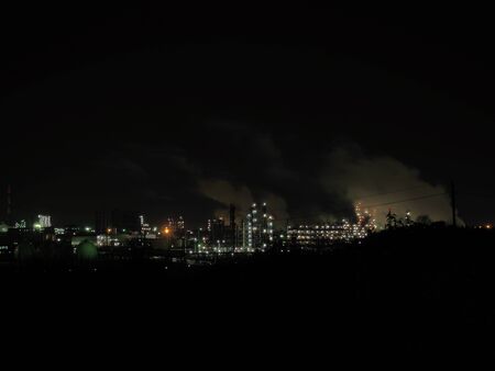industrial stuff during a night with lights and smokesの写真素材