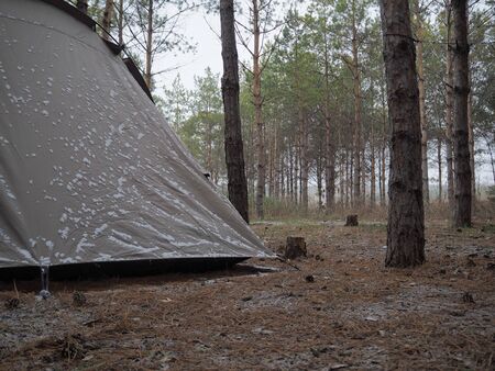Camping tent slightly covered by snow at early Novemberの写真素材