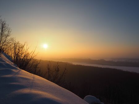Sun reflected by snow in the deep of city parkの写真素材