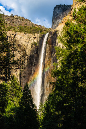 Rainbow crosses Ribbon Fall at Yosemite National Parkの写真素材