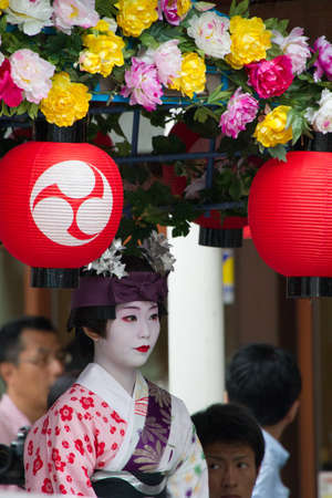 KYOTO - JULY 24: Unidentified Maiko girl (or Geiko lady) on parade of hanagasa in Gion Matsuri (Festival) held on July 24 2013 in Kyoto, Japan. It is one of Kyoto\'s renowned three great festivals. のeditorial素材