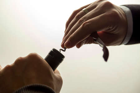 Opening a bottle of wine with corkの写真素材