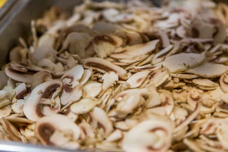 sliced mushrooms ready for pizzaの写真素材