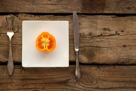 Pepper as sorce of vitamins for vegeterians and people on diet on wooden background.の写真素材