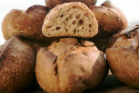 Loaves of homemade bread with one sliced bun. Concept of gluten free bread.